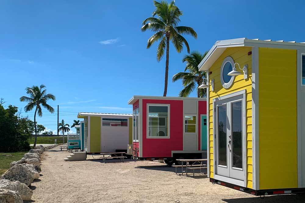 A sunny tiny home resort with palm trees