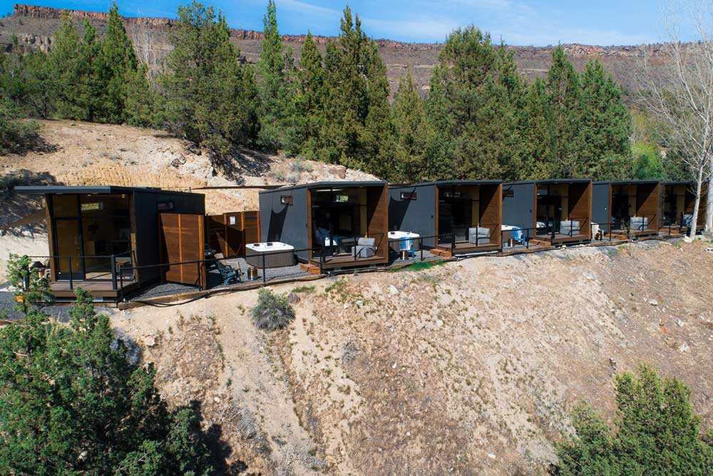 Tiny home workforce housing with pine trees in background, built by Tiny Heirloom